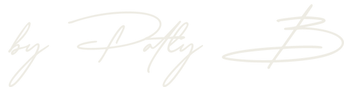 A close-up of a light beige script logo reading 'by Patty B' on a transparent background.
