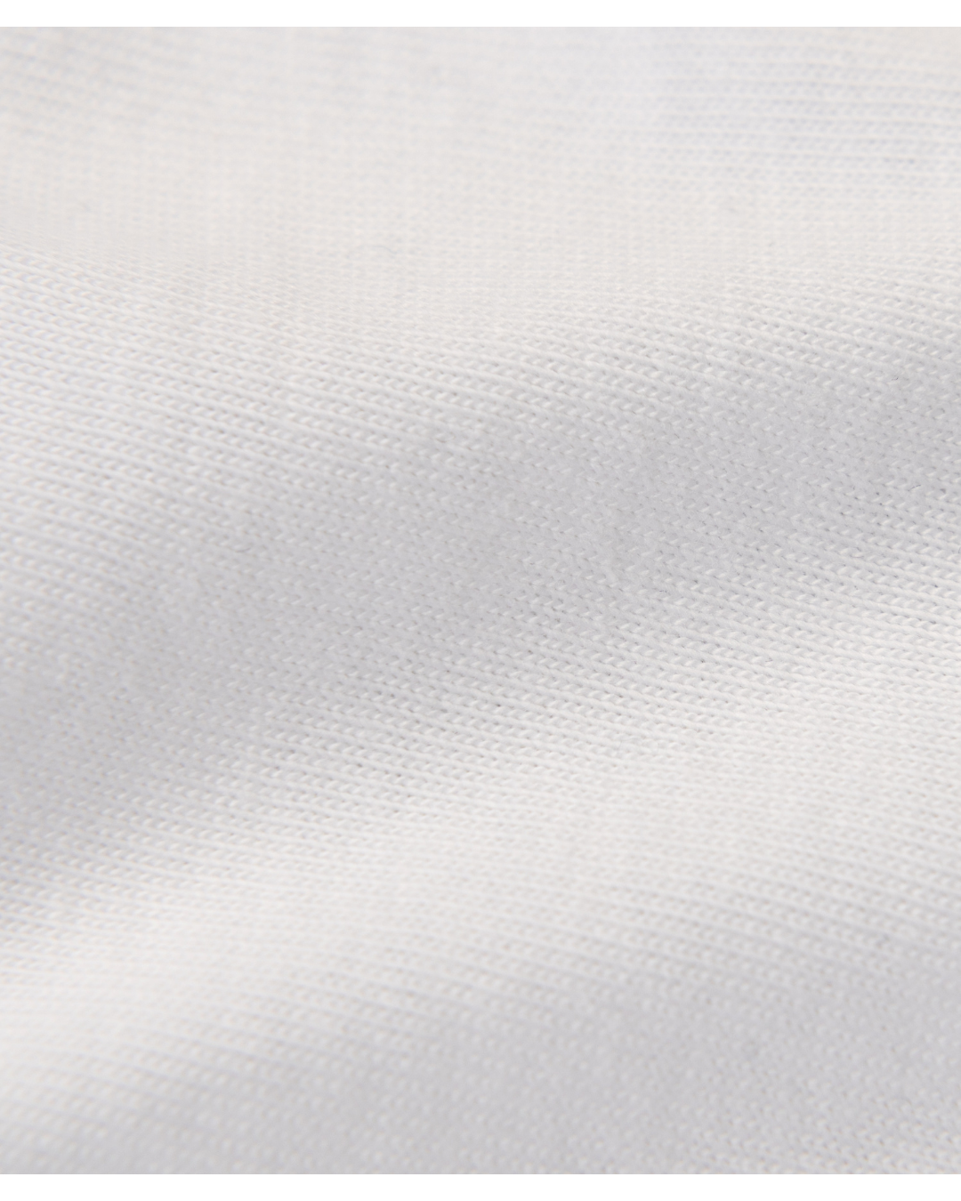 A close-up of a light gray textured fabric with a fine woven pattern and soft diagonal folds.